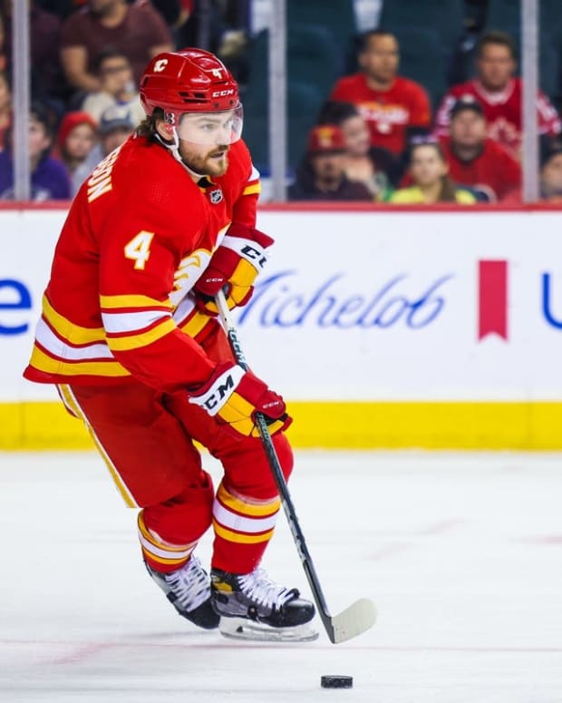 Oct 20, 2022; Calgary, Alberta, CAN; Calgary Flames defenseman Rasmus Andersson (4) skates with the puck against the Buffalo Sabres during the first period at Scotiabank Saddledome. Mandatory Credit: Sergei Belski-USA TODAY Sports